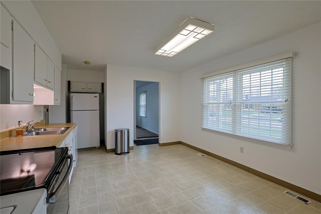 4307 Meadowcroft Road Dayton, OH 45429 - Photo 12 of 26 This functional kitchen and dining area features practical flooring and ample natural light.
