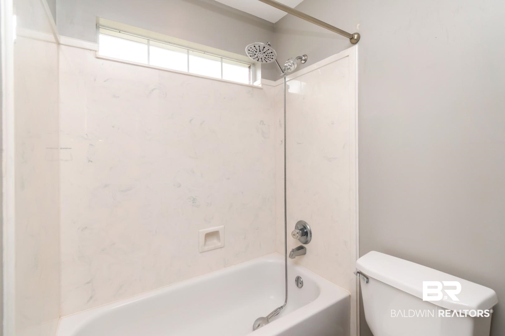 10691 Hunters Ridge Drive Mobile, AL 36695 - Photo 22 of 37 Bathtub with integrated shower, white patterned tile surround, and a chrome shower fixture