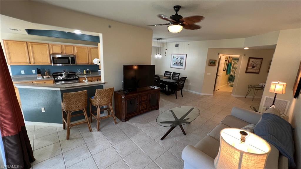 5705 Mayflower Way Ave Maria, FL 34142 - Photo 19 of 34 a view of a livingroom with workspace and a couch