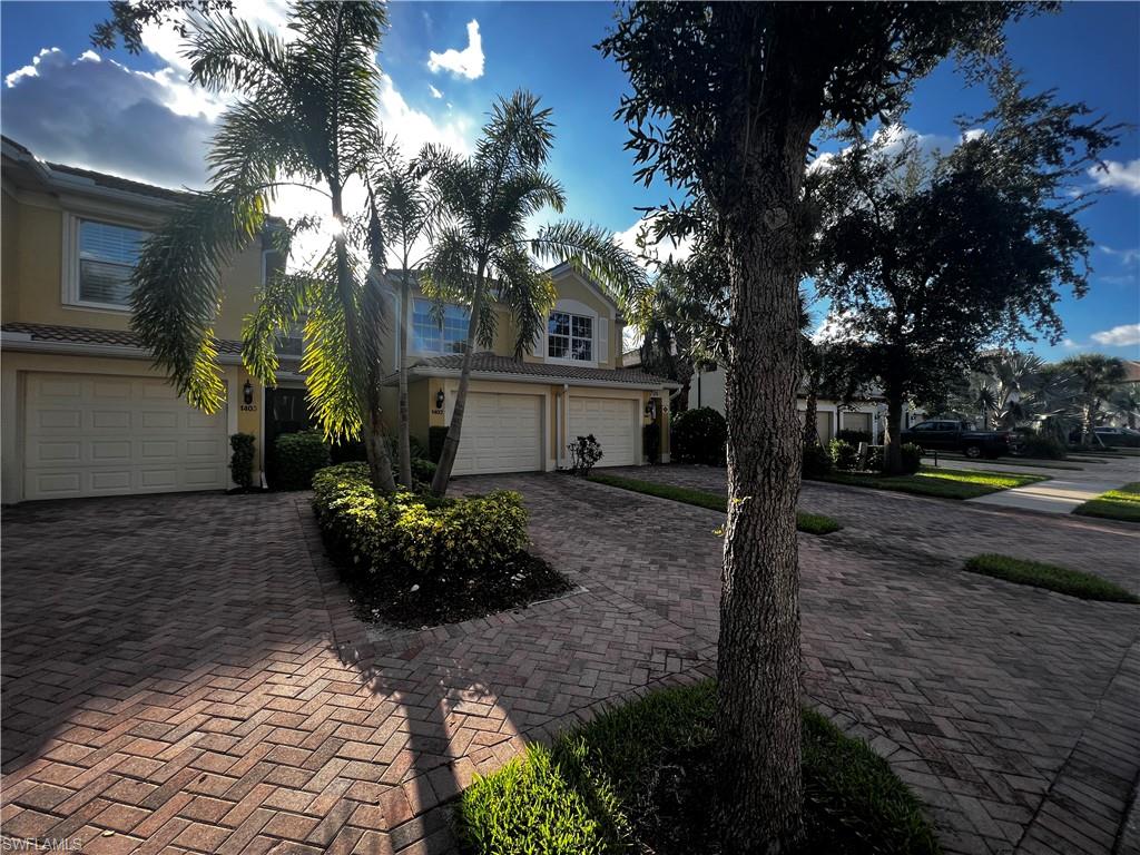 5705 Mayflower Way Ave Maria, FL 34142 - Photo 26 of 34 a front view of a house with garden