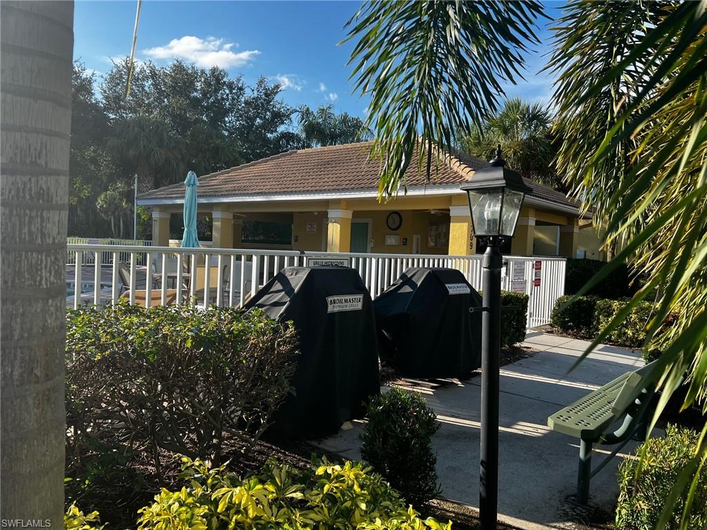 5705 Mayflower Way Ave Maria, FL 34142 - Photo 34 of 34 a front view of a house with garden