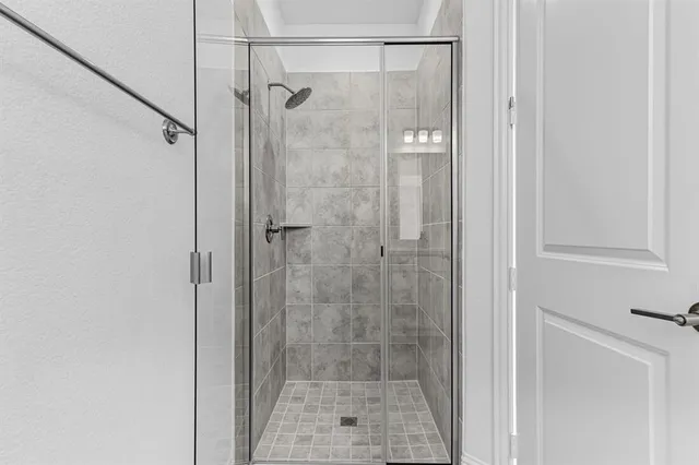 a bathroom with a glass door shower
