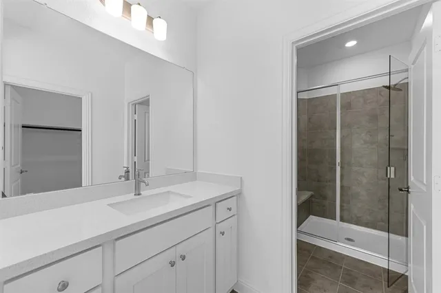 a bathroom with a shower sink and toilet