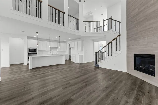 a view of staircase and kitchen with wooden floor
