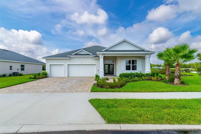 a front view of a house with a yard and garage