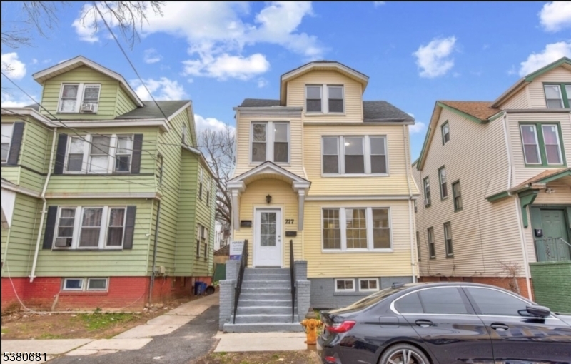 a front view of a house with parking space