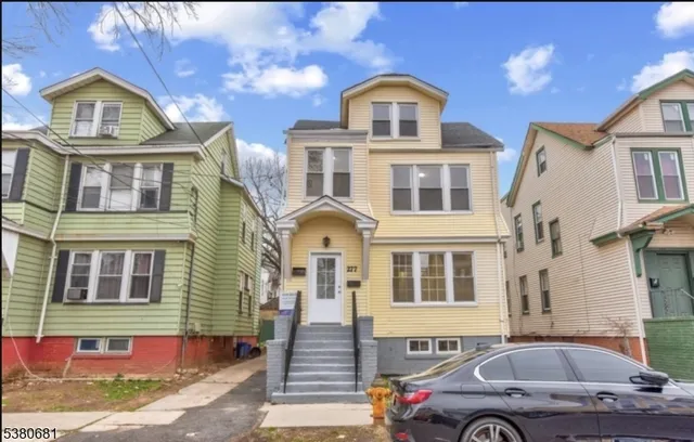 a front view of a house with parking space