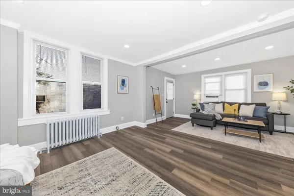 a spacious bedroom with a bed a couch and a window
