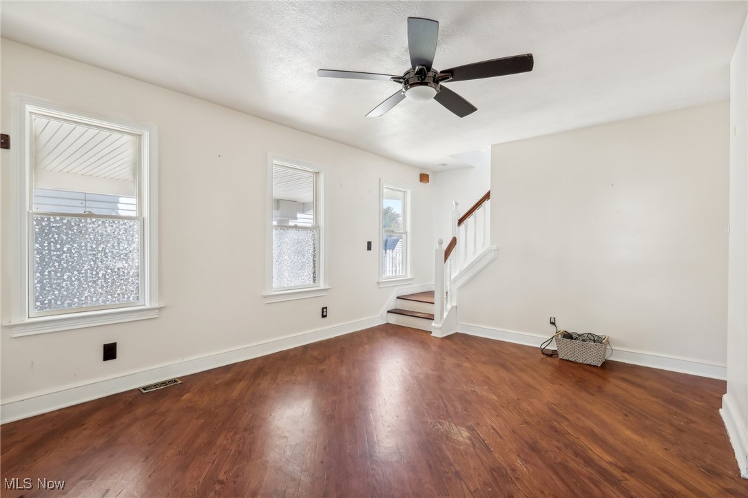 12006 Derby Road Garfield Heights, OH 44125 - Photo 6 of 45 Living room with ceiling fan, dark hardwood / wood-style floors, and plenty of natural light