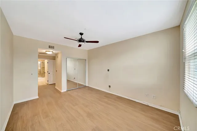 a spacious bathroom with a glass shower door and a bathtub