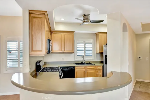 a kitchen with kitchen island stainless steel appliances a sink and a window