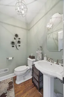 a bathroom with a sink a toilet and a mirror