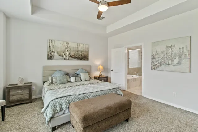 a bedroom with a bed and a painting on the wall