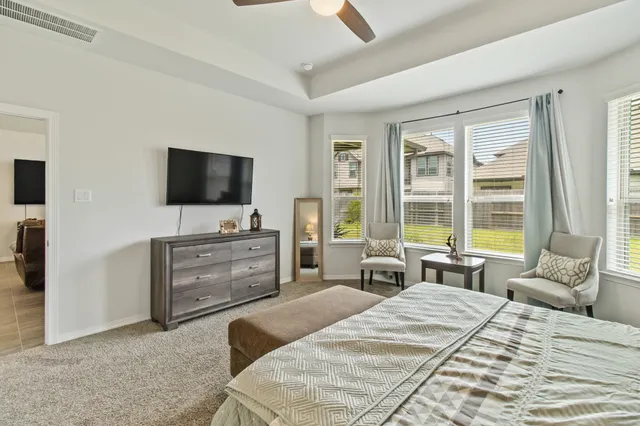 a bed room with television and a bed