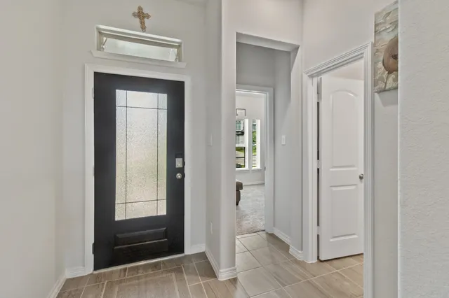 a view of front door with a mirror