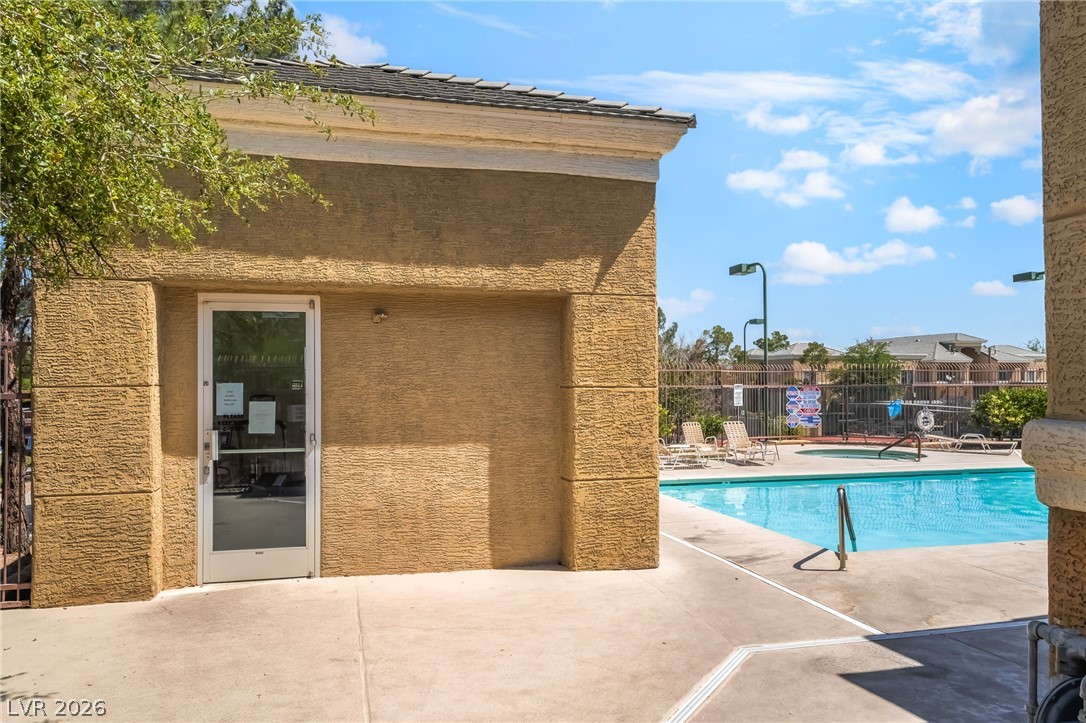 8070 West Russell Road, Unit 2024 Las Vegas, NV 89113 - Photo 18 of 19 An inviting pool area awaits just beyond the textured stucco building.