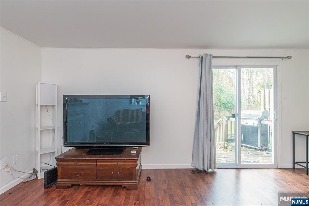 76 Constitution Way, Unit 534 Franklin, NJ 07416 - Photo 11 of 22 a living room with furniture and wooden floor