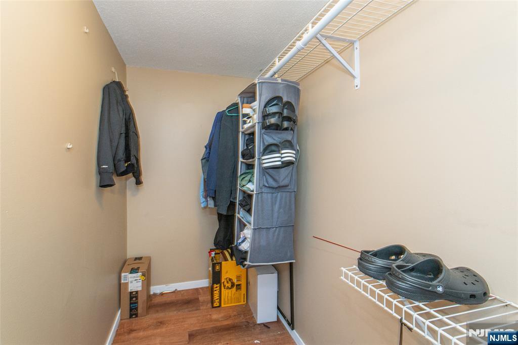 76 Constitution Way, Unit 534 Franklin, NJ 07416 - Photo 13 of 22 a view of walk in closet with clothes and shoes
