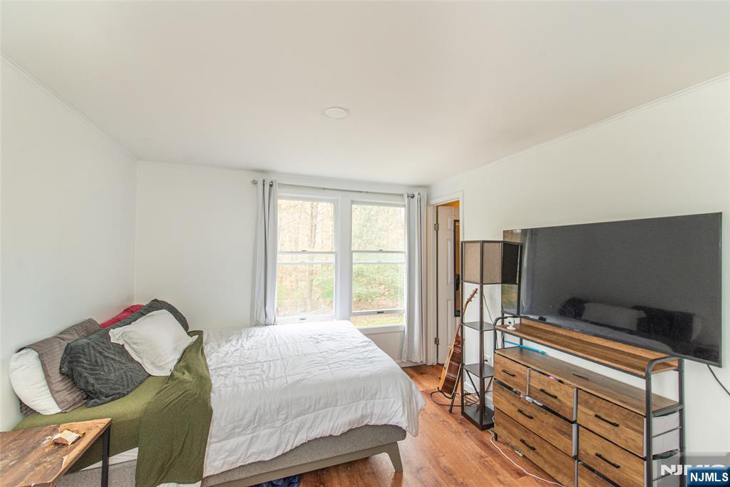 76 Constitution Way, Unit 534 Franklin, NJ 07416 - Photo 14 of 22 a bedroom with a bed and a flat screen tv