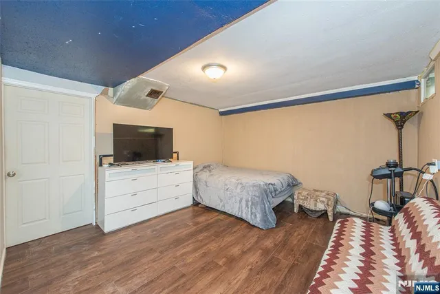 a room with a bed and flat screen tv