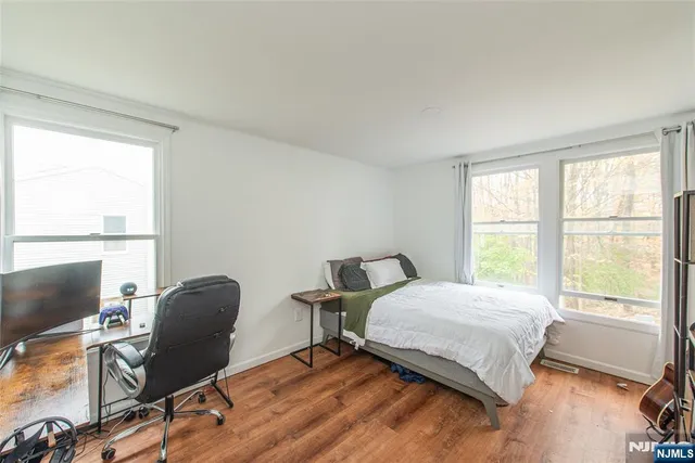 a bedroom with a bed chair and a window