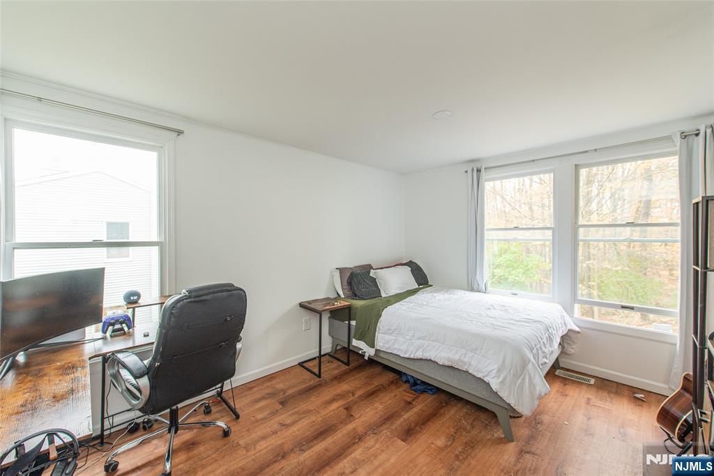76 Constitution Way, Unit 534 Franklin, NJ 07416 - Photo 17 of 22 a bedroom with a bed chair and a window