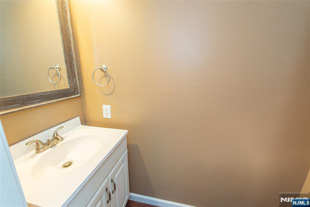 76 Constitution Way, Unit 534 Franklin, NJ 07416 - Photo 18 of 22 a bathroom with a sink and a mirror