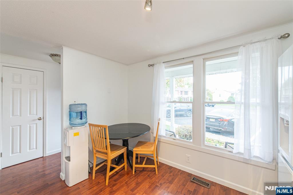 76 Constitution Way, Unit 534 Franklin, NJ 07416 - Photo 6 of 22 a dining room with wooden floor and a window