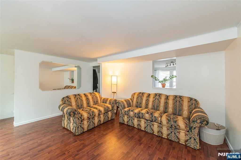 76 Constitution Way, Unit 534 Franklin, NJ 07416 - Photo 7 of 22 a living room with furniture and a wooden floor