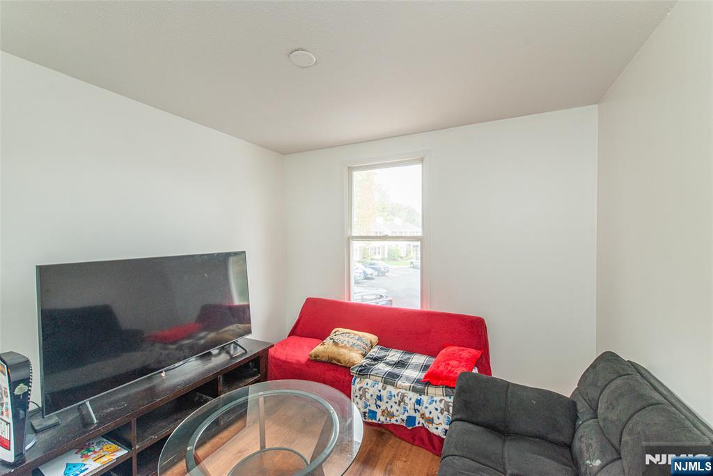 76 Constitution Way, Unit 534 Franklin, NJ 07416 - Photo 10 of 22 a living room with furniture and a flat screen tv