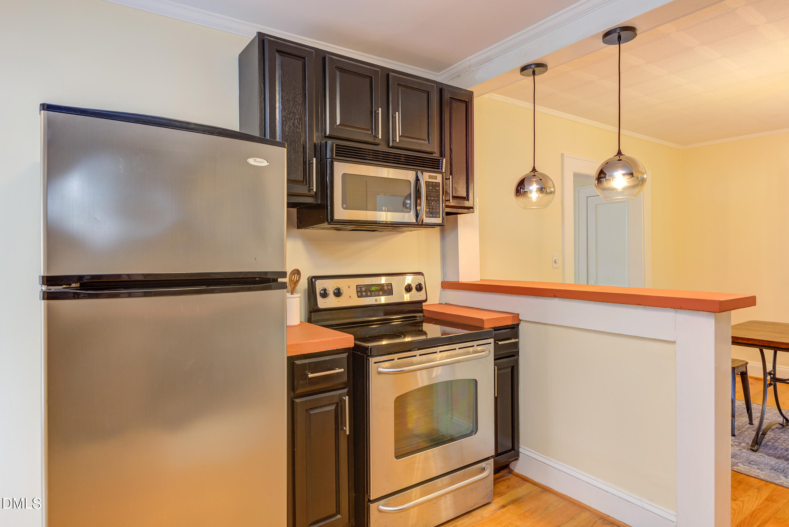 1109 North Elizabeth Street Durham, NC 27701 - Photo 34 of 44 a kitchen with stainless steel appliances granite countertop a refrigerator and a stove top oven