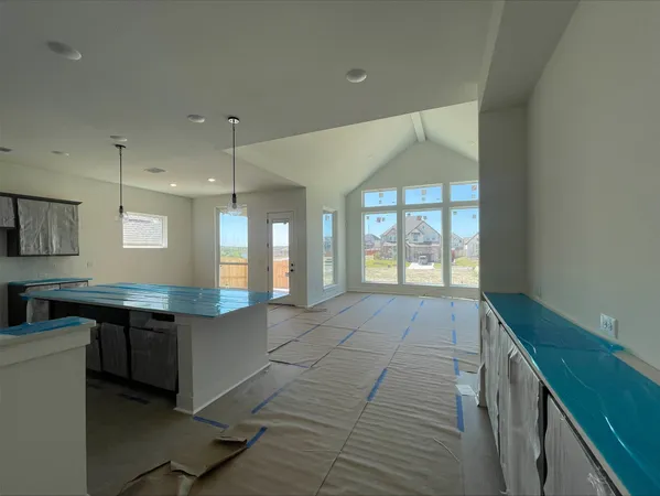 a spacious bathroom with a granite countertop sink a toilet a mirror and window
