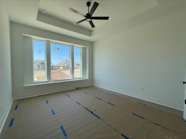 a view of a livingroom with a ceiling fan and window