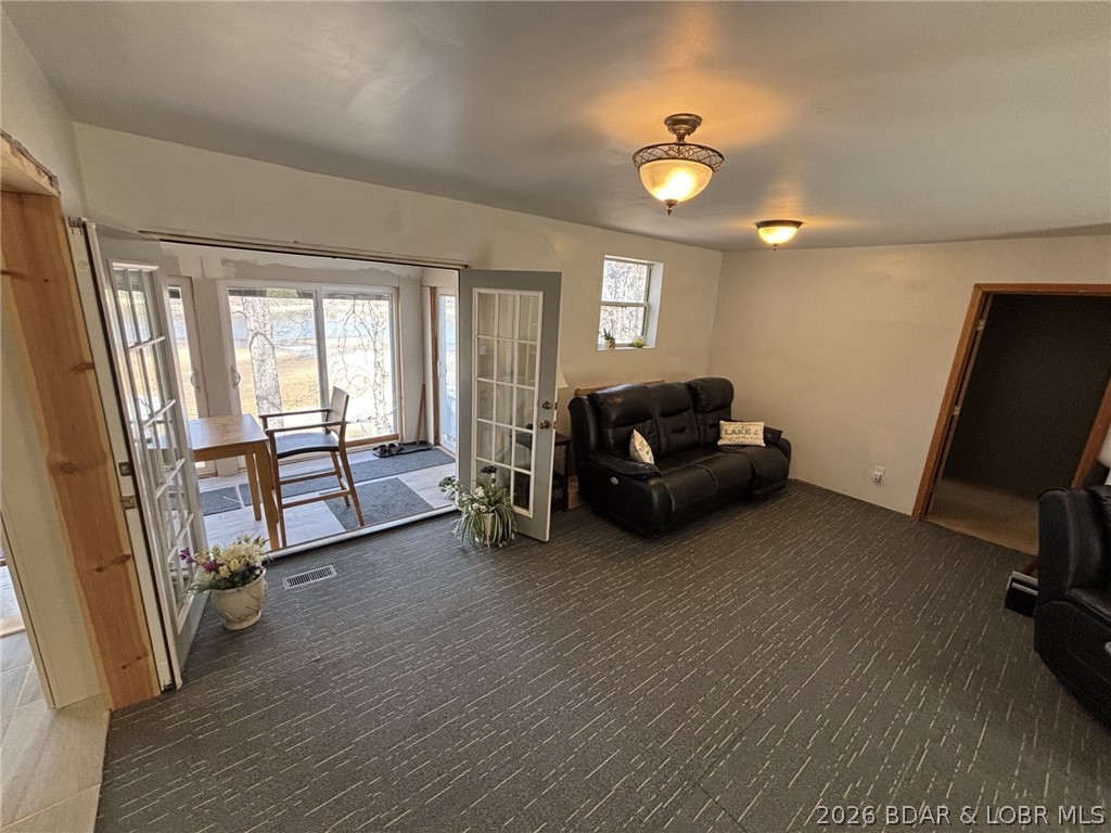 1265 Lick Creek Road Edwards, MO 65326 - Photo 12 of 29 living room with entrance to sun room and bathroom