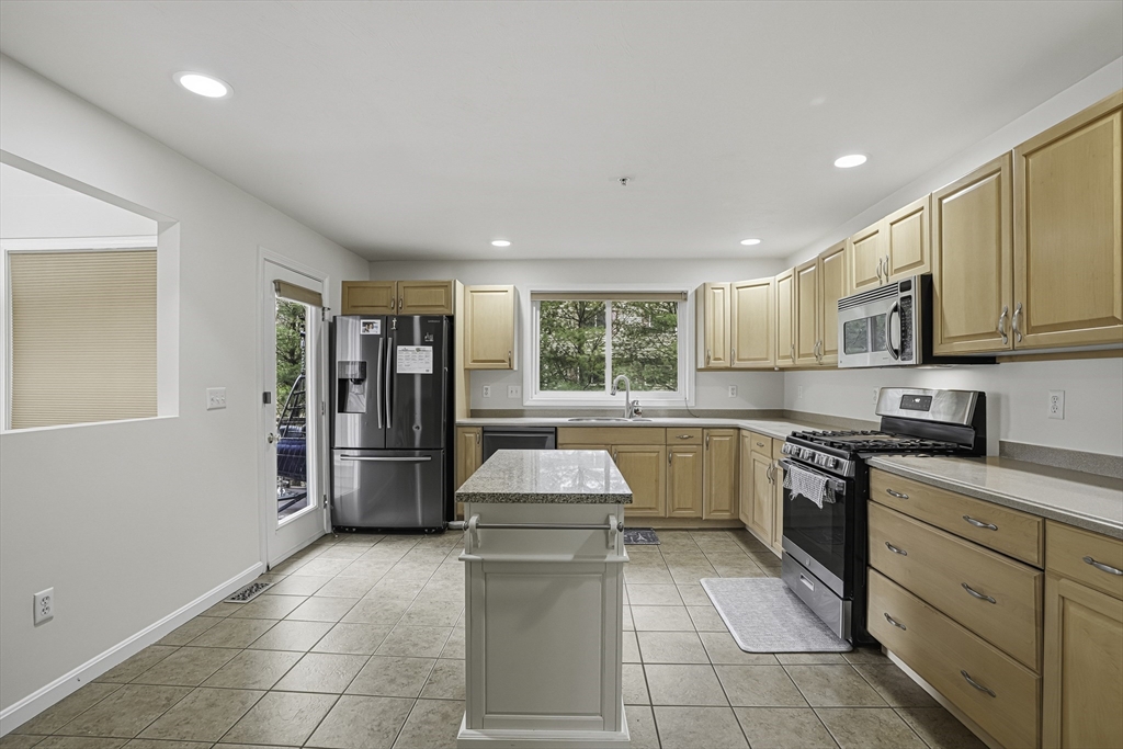 153 America Boulevard, Unit 153 Ashland, MA 01721 - Photo 14 of 42 a kitchen with a sink cabinets and window