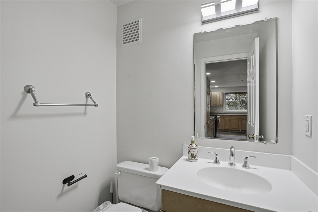 153 America Boulevard, Unit 153 Ashland, MA 01721 - Photo 20 of 42 a bathroom with a sink a toilet and mirror