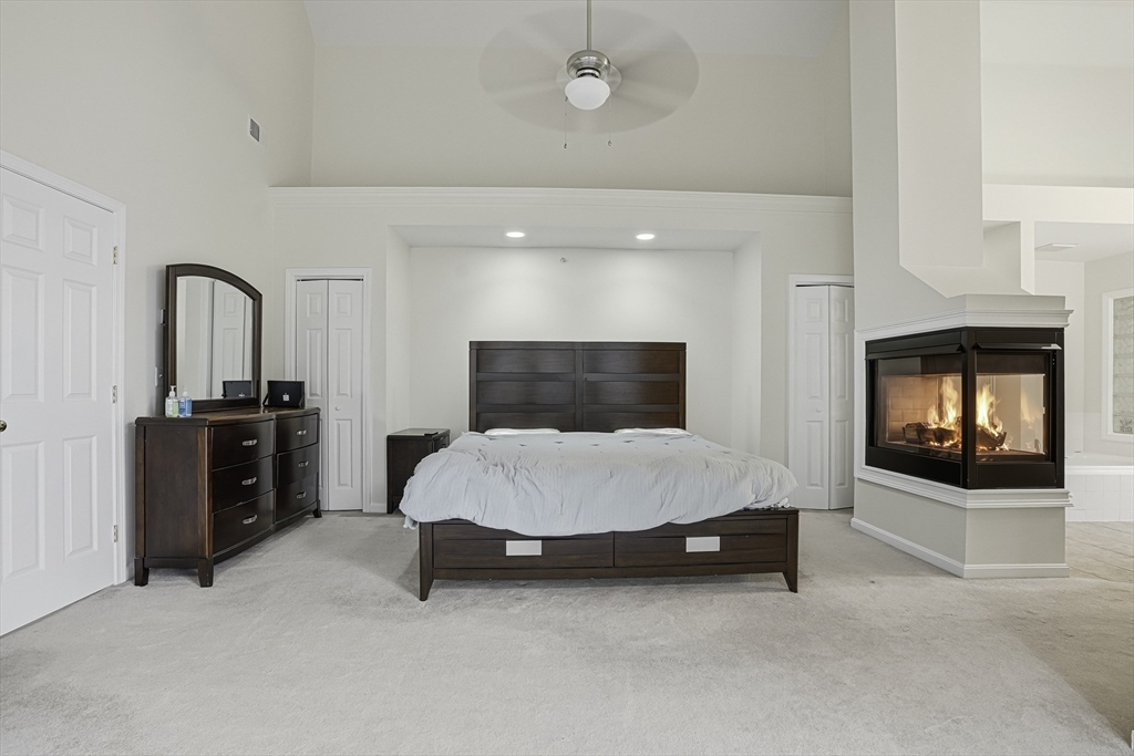 153 America Boulevard, Unit 153 Ashland, MA 01721 - Photo 27 of 42 a living room with furniture and a fireplace