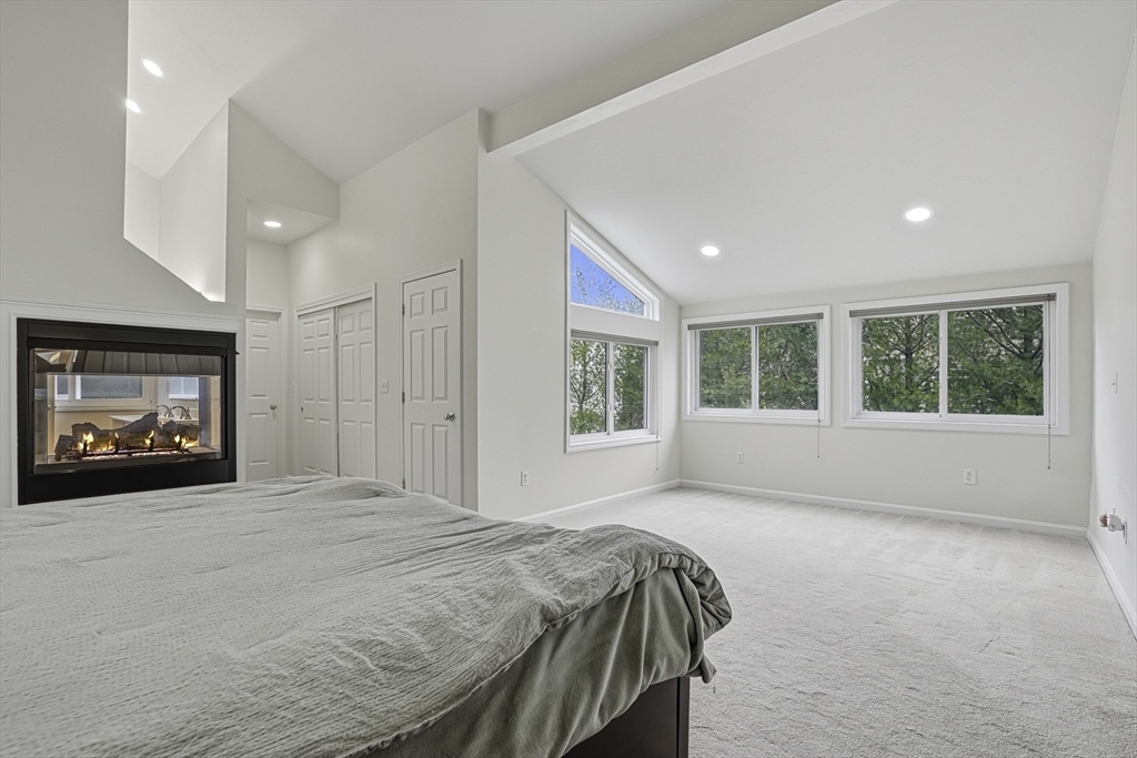 153 America Boulevard, Unit 153 Ashland, MA 01721 - Photo 28 of 42 a spacious bedroom with a large bed and a window