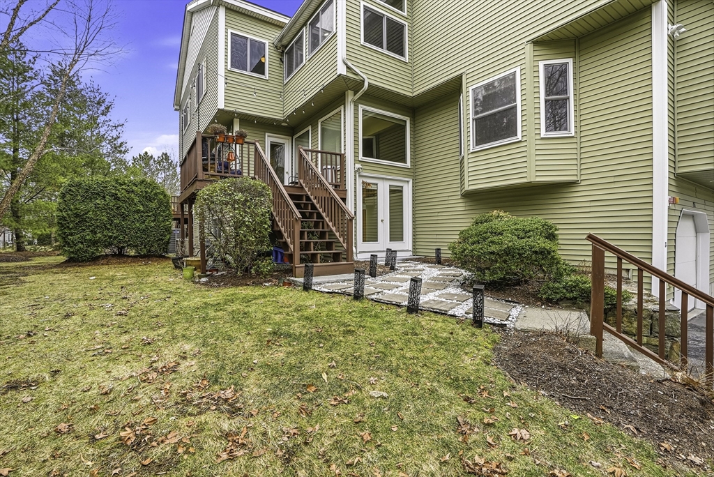 153 America Boulevard, Unit 153 Ashland, MA 01721 - Photo 3 of 42 a view of a house with backyard and sitting area