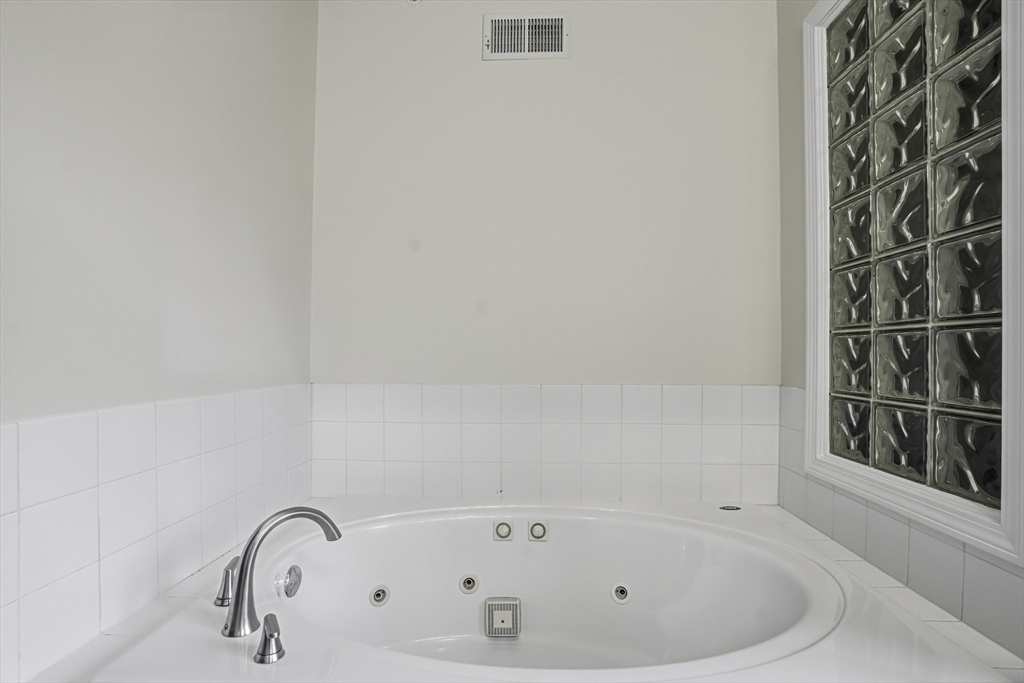 153 America Boulevard, Unit 153 Ashland, MA 01721 - Photo 33 of 42 a white bath tub sitting next to a window