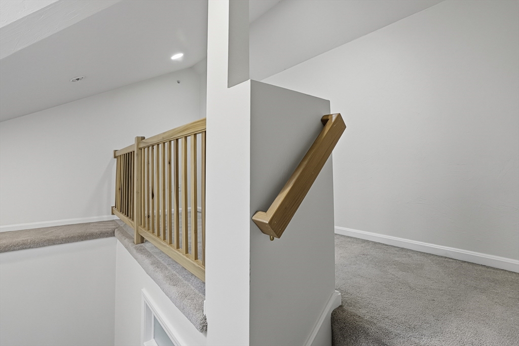 153 America Boulevard, Unit 153 Ashland, MA 01721 - Photo 35 of 42 a view of staircase with railing and white walls