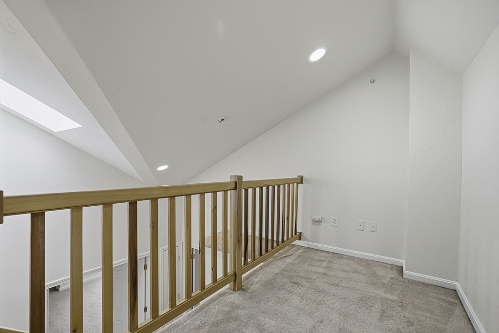 153 America Boulevard, Unit 153 Ashland, MA 01721 - Photo 36 of 42 a view of a hallway with wooden floor