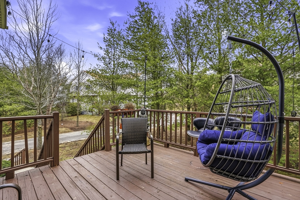 153 America Boulevard, Unit 153 Ashland, MA 01721 - Photo 40 of 42 a view of balcony with wooden floor and outdoor seating