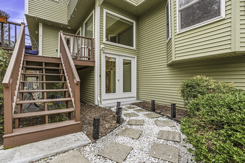 153 America Boulevard, Unit 153 Ashland, MA 01721 - Photo 4 of 42 a front view of a house with a yard