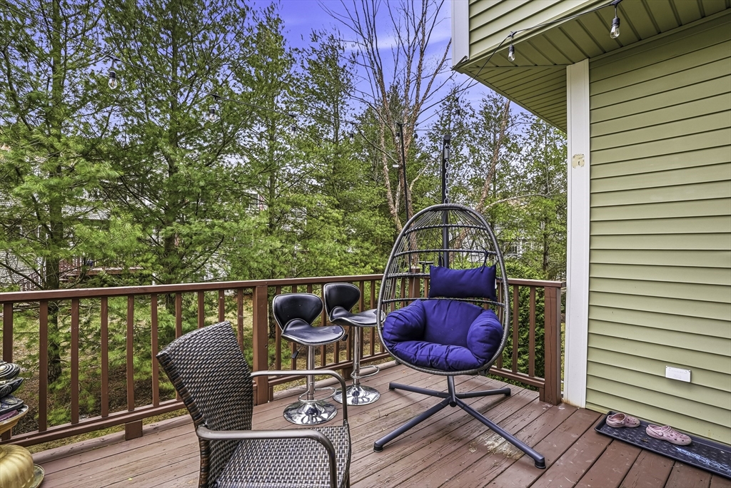 153 America Boulevard, Unit 153 Ashland, MA 01721 - Photo 41 of 42 a balcony with chairs and a potted plant