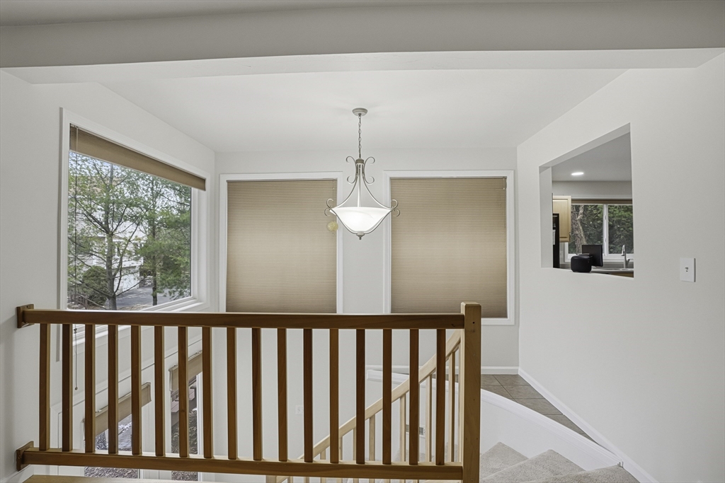 153 America Boulevard, Unit 153 Ashland, MA 01721 - Photo 6 of 42 a view of a hallway with windows and chandelier