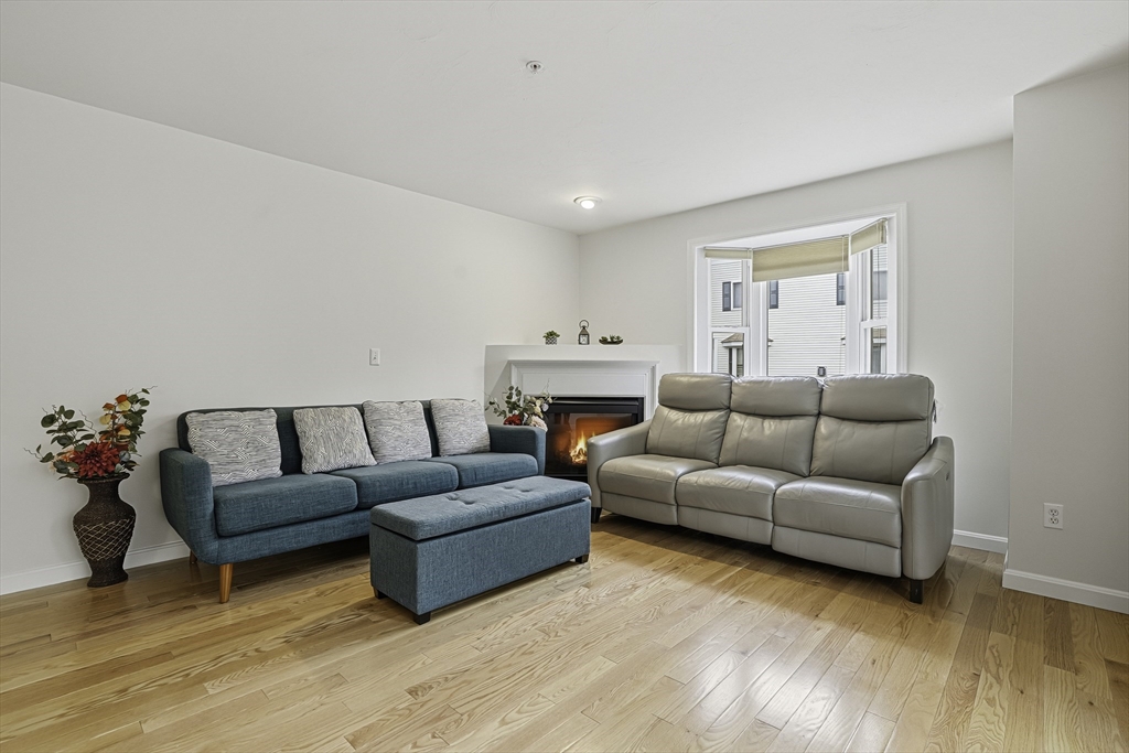 153 America Boulevard, Unit 153 Ashland, MA 01721 - Photo 10 of 42 a living room with furniture window and a wooden floor