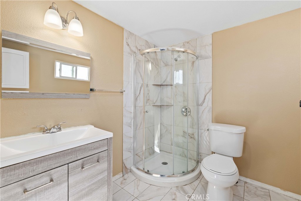 43850 20th Street East, Unit 265 Lancaster, CA 93535 - Photo 12 of 19 a bathroom with a sink toilet and shower
