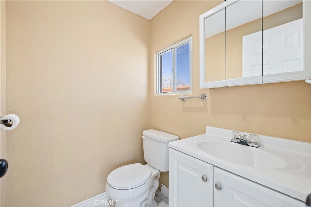 43850 20th Street East, Unit 265 Lancaster, CA 93535 - Photo 15 of 19 a bathroom with a sink a toilet and a window
