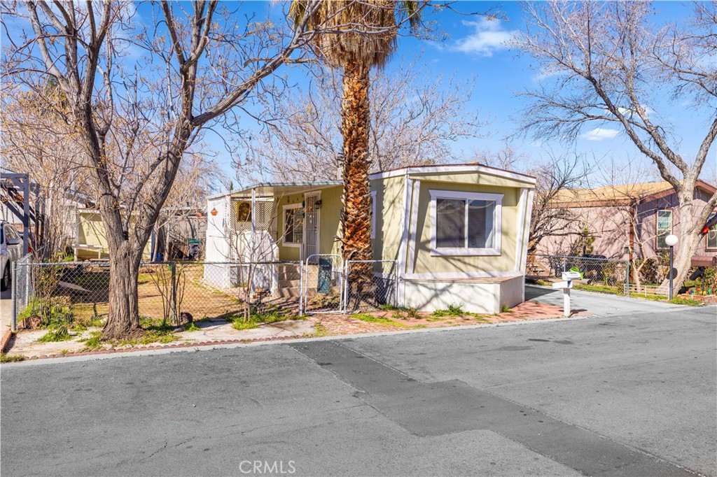 43850 20th Street East, Unit 265 Lancaster, CA 93535 - Photo 4 of 19 a view of a house with large trees